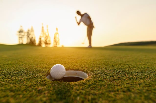 lifestyle-golf-activity-outdoor-sport-golfer-concept-golf-balls-that-are-going-be-hole-by-golfers-green-grass-golf-course-sunset